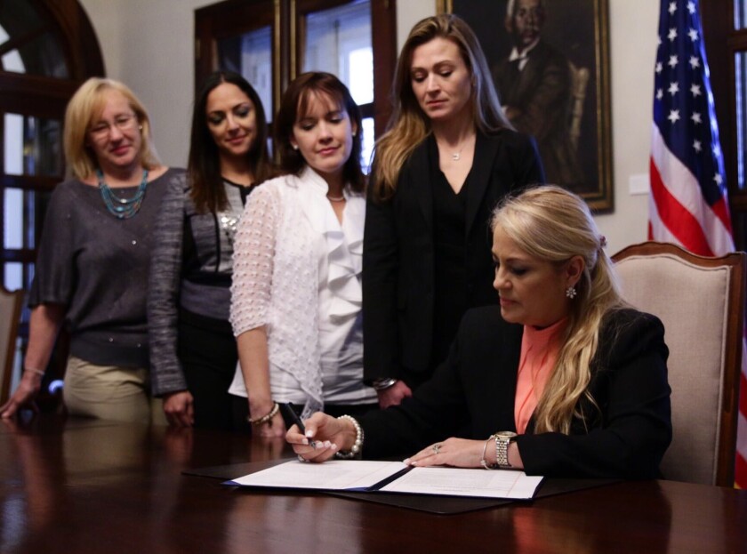 Puerto Rico Governor Wanda Vazquez signing a document