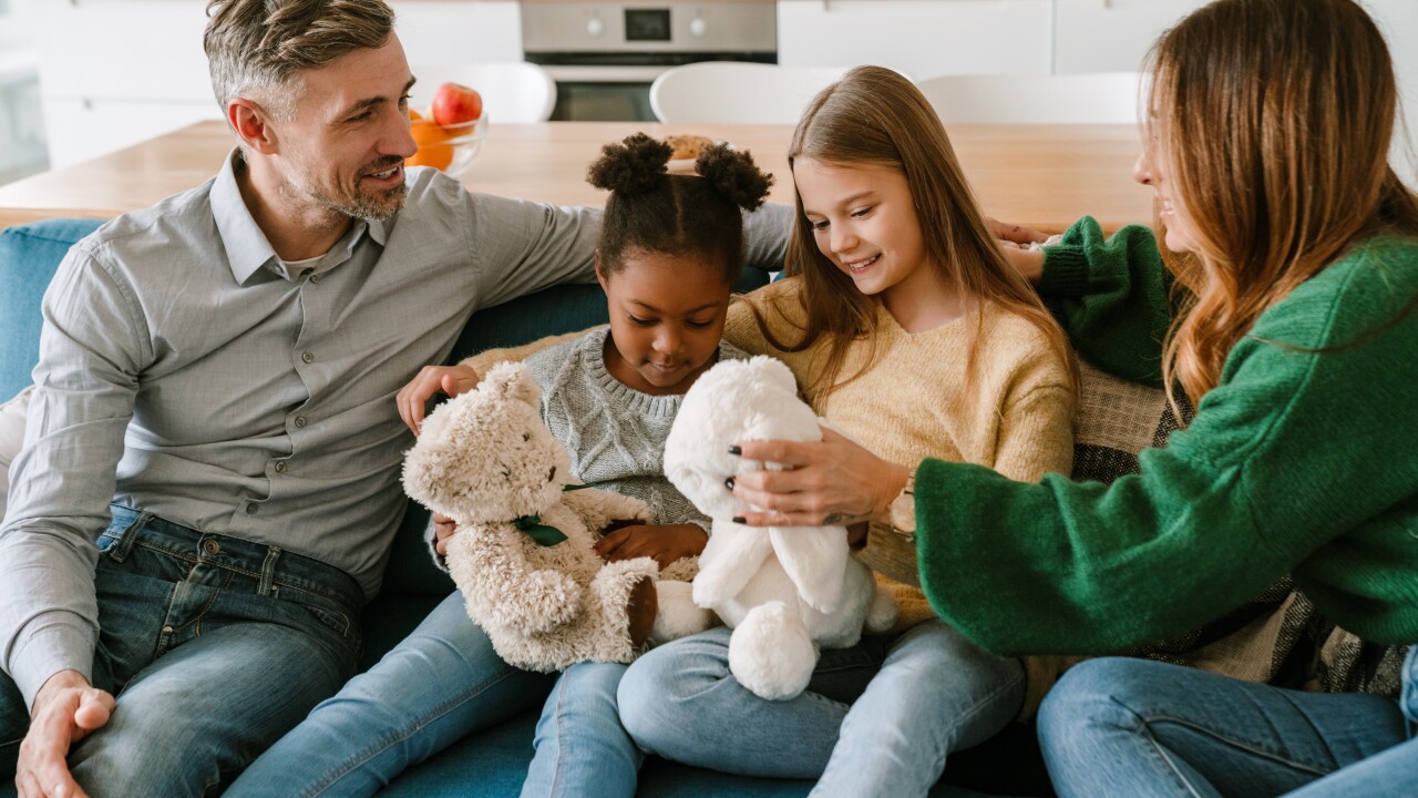 Parents with their adoptive children.