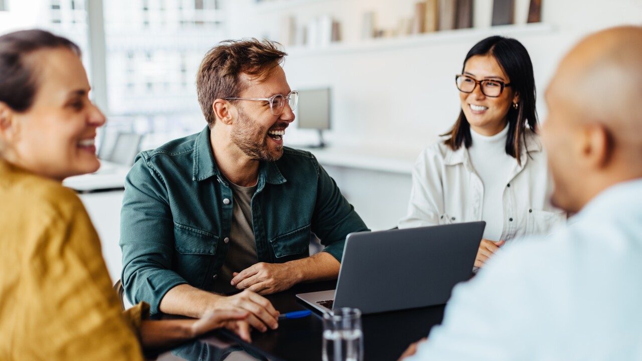 Group of employees sitting at table