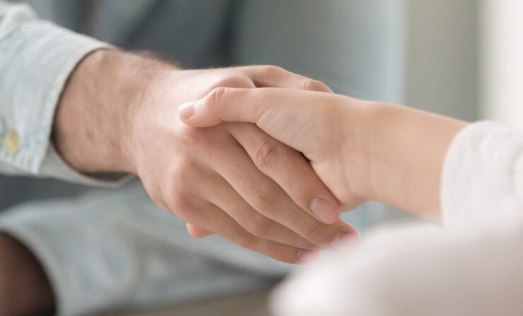 Close up panoramic image businesswoman and businessman shaking hands
