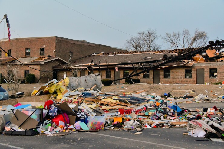A portable classroom trailer frame rests on the elementary school building roof of Donelson Christian Academy destruction following a deadly tornado on March 3, 2020, in Nashville, Tenn.